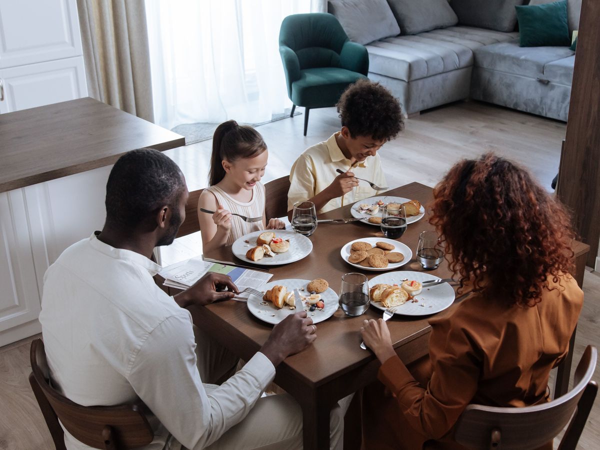 A family laughing together around the breakfast table